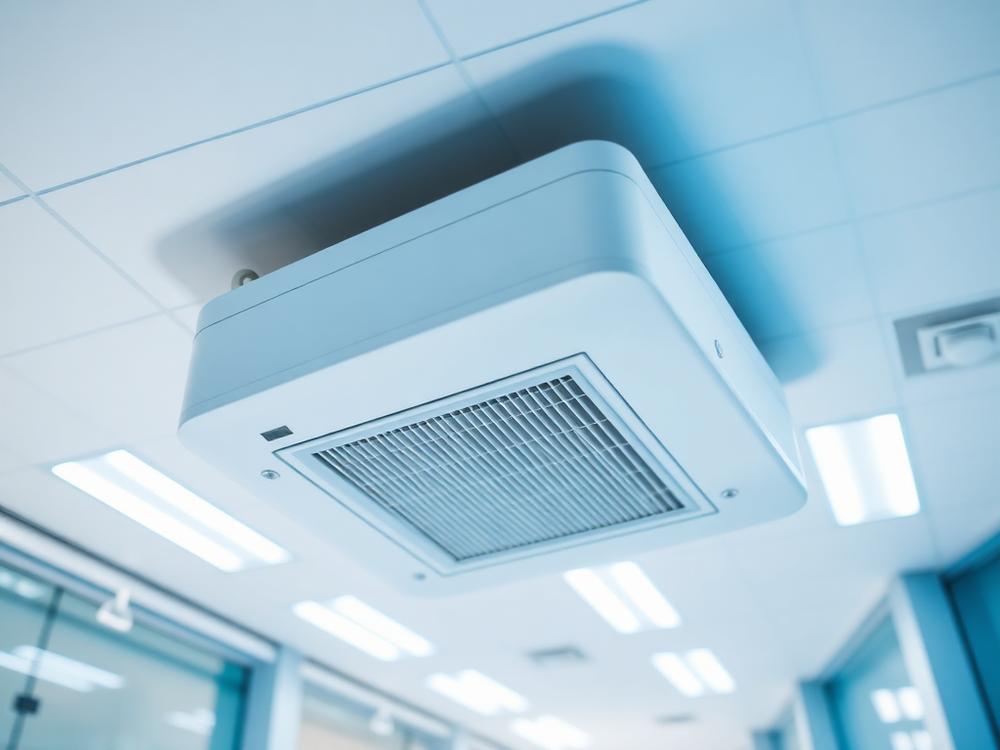 Illustrative image of a ceiling cassette air conditioner in a commercial ceiling